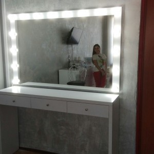 Mirror and dressing room table. Makeup artist's workplace