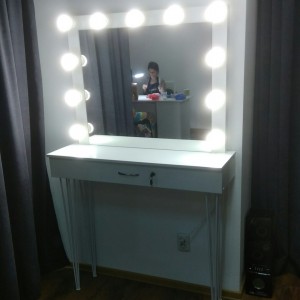 Makeup table with metal legs.