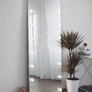 A full-length mirror with light bulbs.