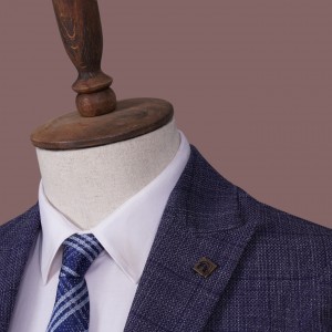 Modern youth classic three-piece suit in deep blue, Italian style, in a subtly noticeable checkered pattern.